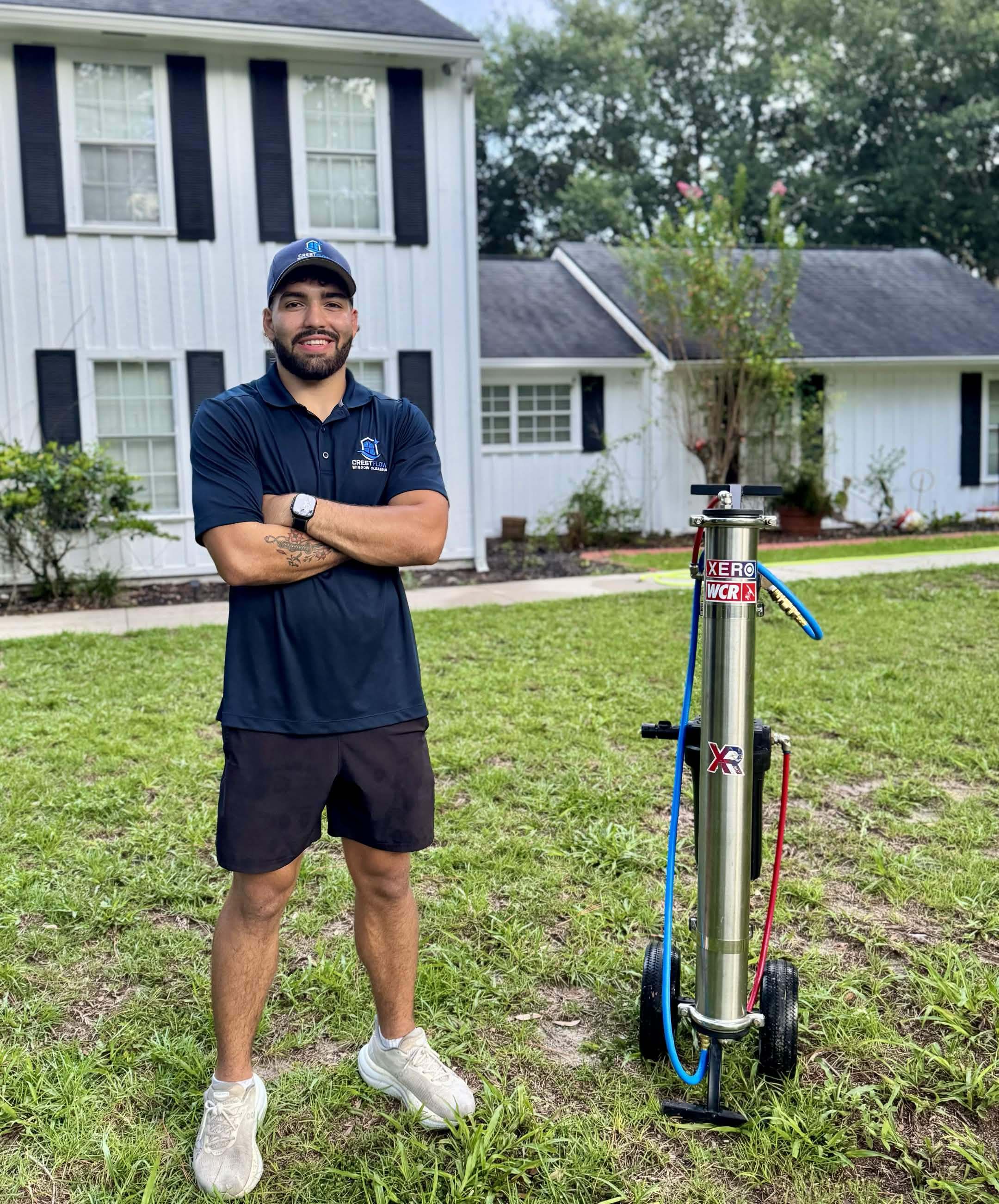 CrestFlow technician standing beside the purified-water filtration cart outside a Palm Coast home